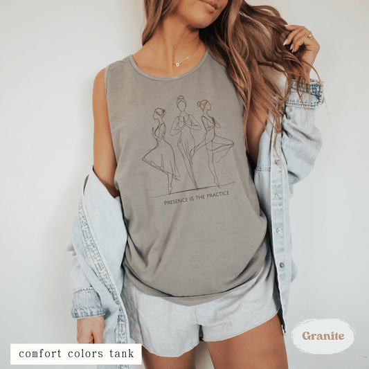 Woman wearing Presence Is the Practice Yoga Tank Top – minimalist line art design on ivory Comfort Colors tank
