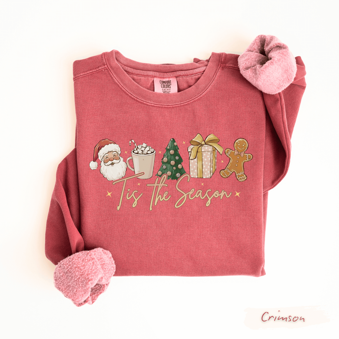 Folded red comfort colors crimson sweatshirt with Christmas-themed graphics and text on a white background