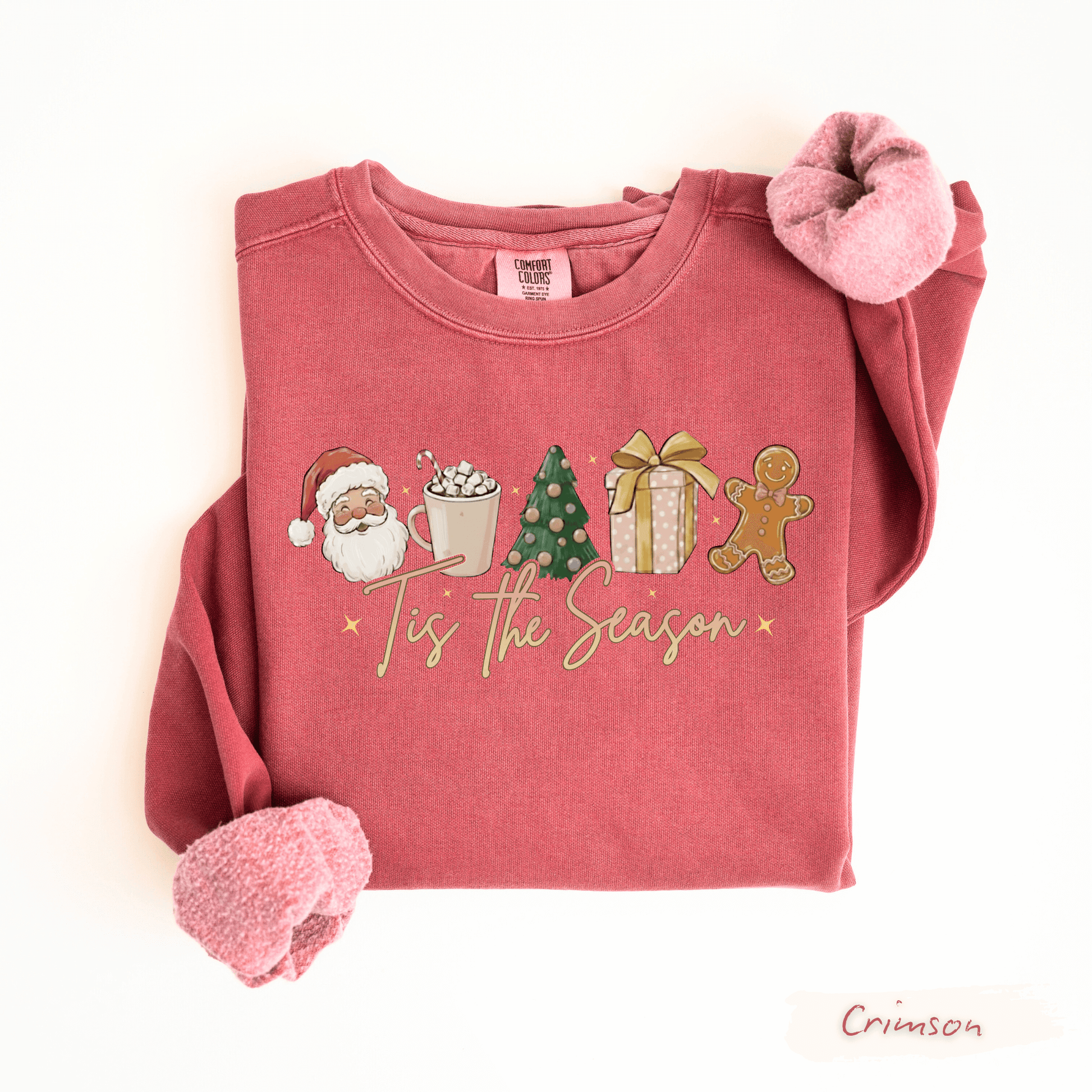 Folded red comfort colors crimson sweatshirt with Christmas-themed graphics and text on a white background