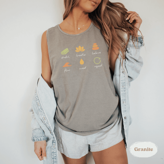 Person wearing a gray tank top with colorful designs and text, standing against a white background.