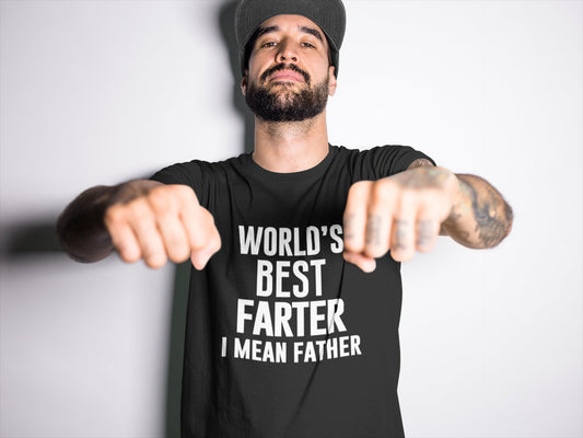 Man wearing a black “World’s Best Farter I Mean Father” T-shirt, standing confidently with fists raised toward the camera in a playful, bold pose.








