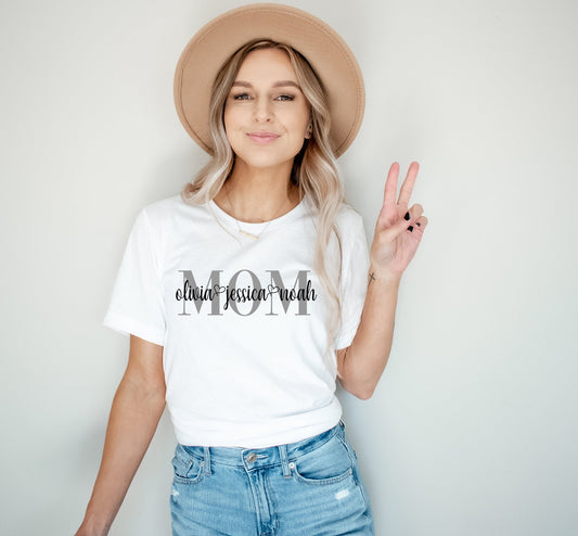 Model wearing Custom Mom Shirt with Kids’ Names in script font – Personalized Mother’s Day Gift by Zazations
