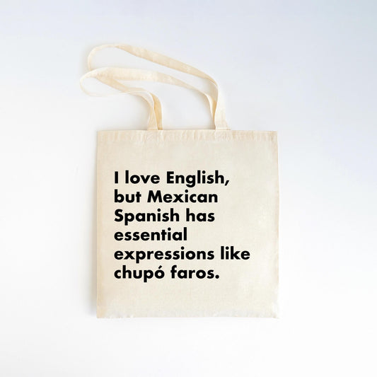  a cotton tote bag featuring the phrase “chupó faros” from the Manuel Quintero quote collection.


