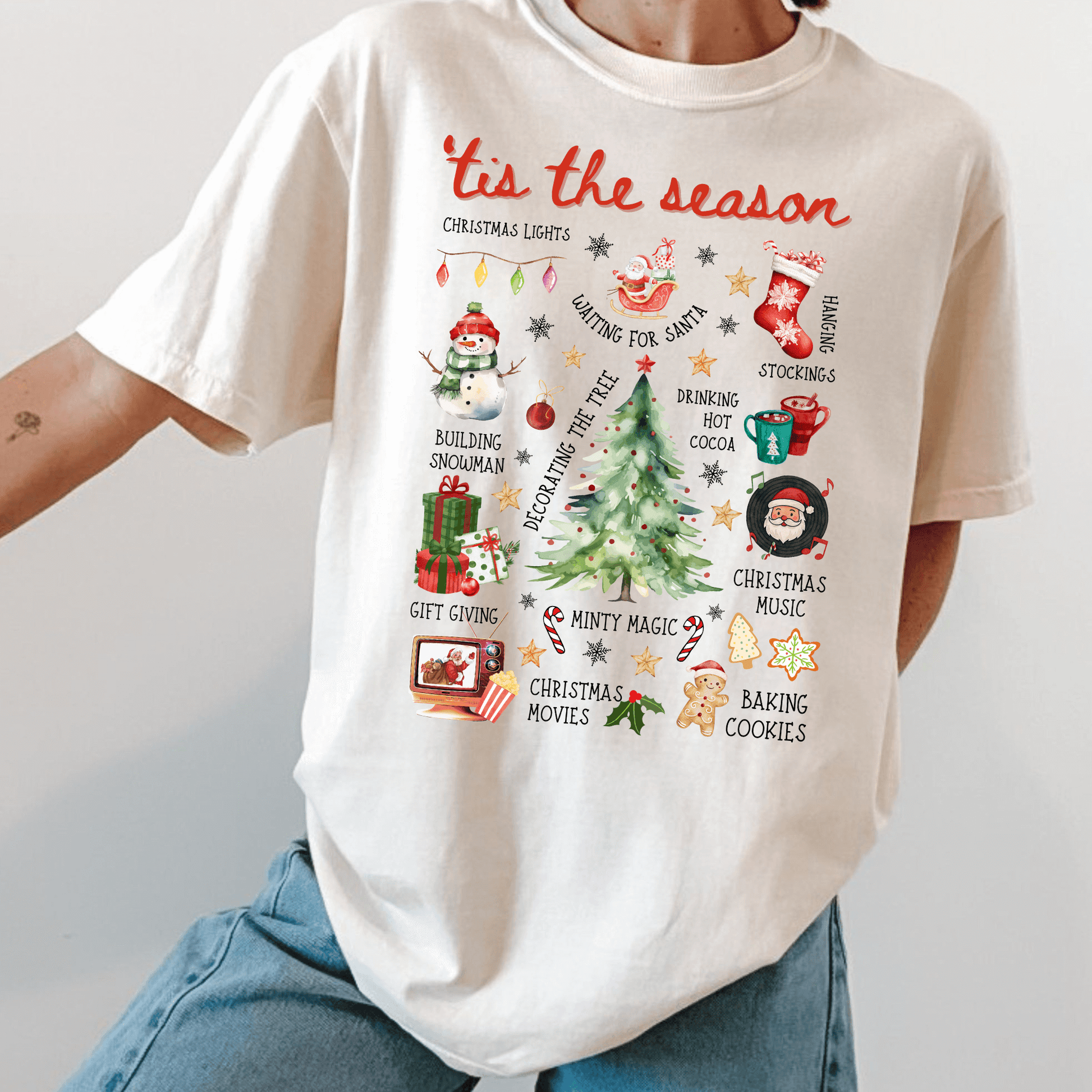 Tis the Season Holiday Activities Shirt Comfort Colors in ivory with Christmas checklist design of tree, cocoa, movies, cookies, and lights